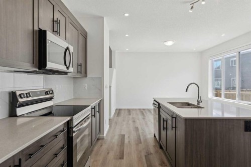 25 Yorkstone Row Sw, Calgary, AB - Indoor Photo Showing Kitchen With Stainless Steel Kitchen With Double Sink With Upgraded Kitchen