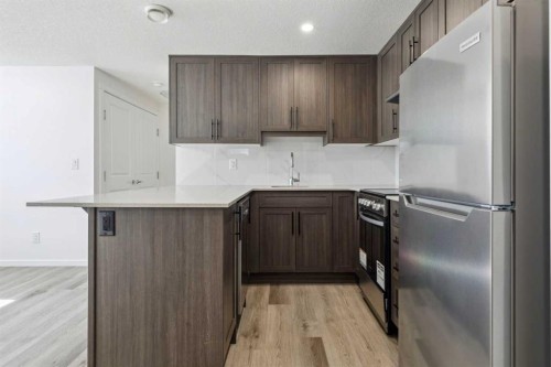 25 Yorkstone Row Sw, Calgary, AB - Indoor Photo Showing Kitchen With Stainless Steel Kitchen