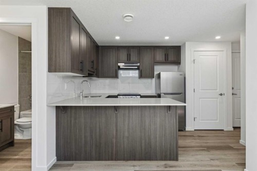 25 Yorkstone Row Sw, Calgary, AB - Indoor Photo Showing Kitchen With Upgraded Kitchen