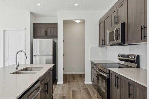 25 Yorkstone Row Sw, Calgary, AB - Indoor Photo Showing Kitchen With Stainless Steel Kitchen With Double Sink With Upgraded Kitchen