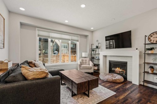 65 Sunrise Crescent, Cochrane, AB - Indoor Photo Showing Living Room With Fireplace