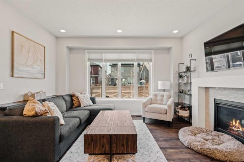 65 Sunrise Crescent, Cochrane, AB - Indoor Photo Showing Living Room With Fireplace