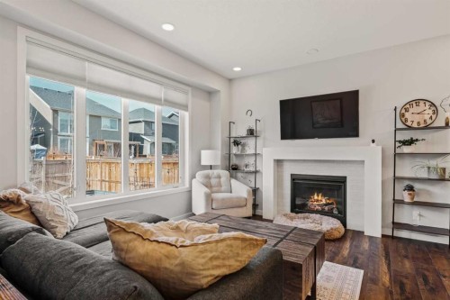 65 Sunrise Crescent, Cochrane, AB - Indoor Photo Showing Living Room With Fireplace