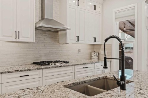 65 Sunrise Crescent, Cochrane, AB - Indoor Photo Showing Kitchen With Double Sink With Upgraded Kitchen