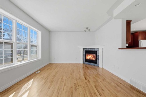 172 Somme Manor Sw, Calgary, AB - Indoor Photo Showing Living Room With Fireplace