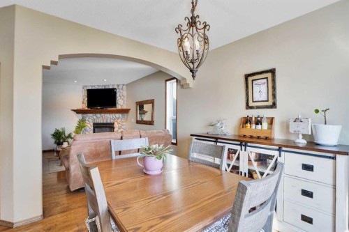32 Harvest Park Way Ne, Calgary, AB - Indoor Photo Showing Dining Room With Fireplace