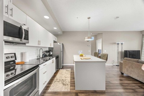 208-4818 Varsity Drive Nw, Calgary, AB - Indoor Photo Showing Kitchen With Stainless Steel Kitchen With Upgraded Kitchen
