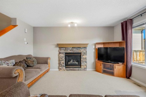 83 Saddlebrook Gardens Ne, Calgary, AB - Indoor Photo Showing Living Room With Fireplace