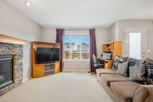 83 Saddlebrook Gardens Ne, Calgary, AB - Indoor Photo Showing Living Room With Fireplace