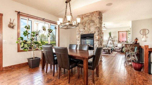 3100 Range Road 254, Strathmore, AB - Indoor Photo Showing Dining Room With Fireplace