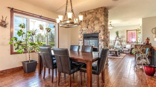 3100 Range Road 254, Strathmore, AB - Indoor Photo Showing Dining Room With Fireplace