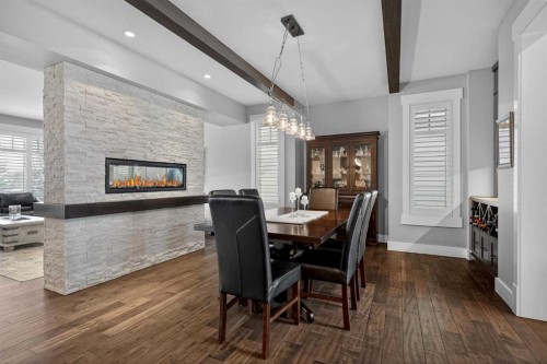 616 Coopers Crescent Sw, Airdrie, AB - Indoor Photo Showing Dining Room With Fireplace