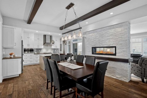 616 Coopers Crescent Sw, Airdrie, AB - Indoor Photo Showing Dining Room With Fireplace