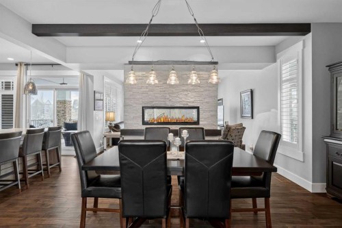 616 Coopers Crescent Sw, Airdrie, AB - Indoor Photo Showing Dining Room With Fireplace