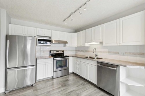 328 Prominence Heights Sw, Calgary, AB - Indoor Photo Showing Kitchen With Double Sink