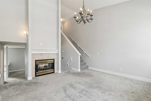 328 Prominence Heights Sw, Calgary, AB - Indoor Photo Showing Other Room With Fireplace