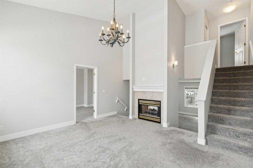 328 Prominence Heights Sw, Calgary, AB - Indoor Photo Showing Other Room With Fireplace