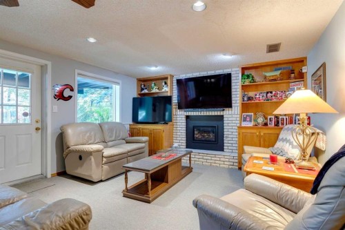 88 Woodacres Drive Sw, Calgary, AB - Indoor Photo Showing Living Room With Fireplace