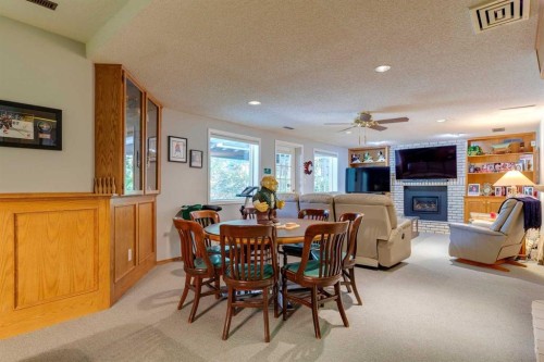 88 Woodacres Drive Sw, Calgary, AB - Indoor Photo Showing Dining Room With Fireplace