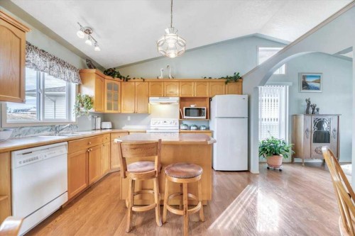 10 Valley Ridge Place Ne, Diamond Valley, AB - Indoor Photo Showing Kitchen With Double Sink
