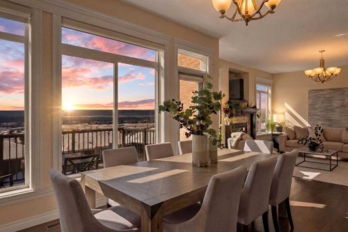 122 Springbluff Boulevard Sw, Calgary, AB - Indoor Photo Showing Dining Room With Fireplace