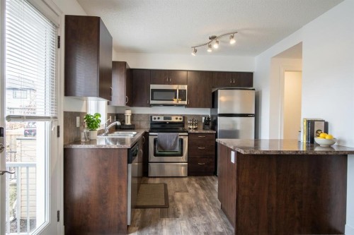132 Copperpond Boulevard Se, Calgary, AB - Indoor Photo Showing Kitchen With Stainless Steel Kitchen With Double Sink