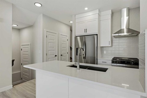 1047 Bayview Crescent, Airdrie, AB - Indoor Photo Showing Kitchen With Double Sink With Upgraded Kitchen