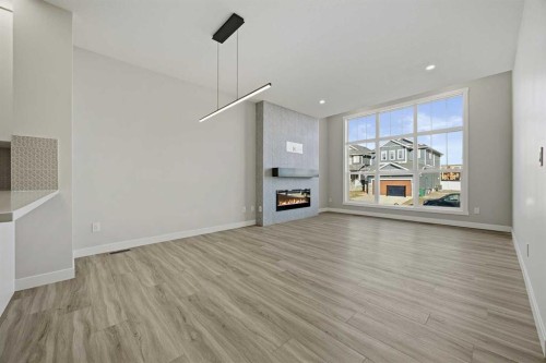 1047 Bayview Crescent, Airdrie, AB - Indoor Photo Showing Other Room With Fireplace