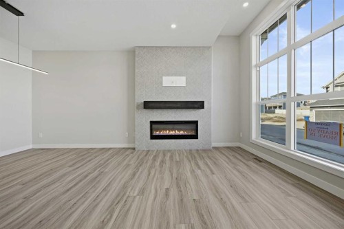 1047 Bayview Crescent, Airdrie, AB - Indoor Photo Showing Other Room With Fireplace