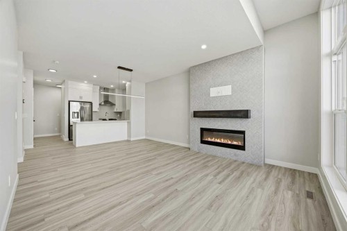 1047 Bayview Crescent, Airdrie, AB - Indoor Photo Showing Living Room With Fireplace