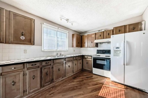 2610 Dover Ridge Drive Se, Calgary, AB - Indoor Photo Showing Kitchen With Double Sink