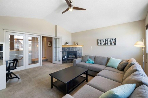 28 West Springs Close Sw, Calgary, AB - Indoor Photo Showing Living Room With Fireplace