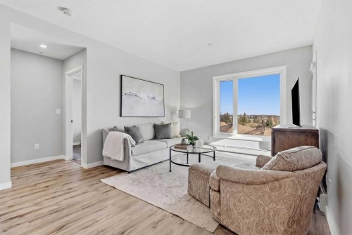 301-71 Shawnee Common Sw, Calgary, AB - Indoor Photo Showing Living Room