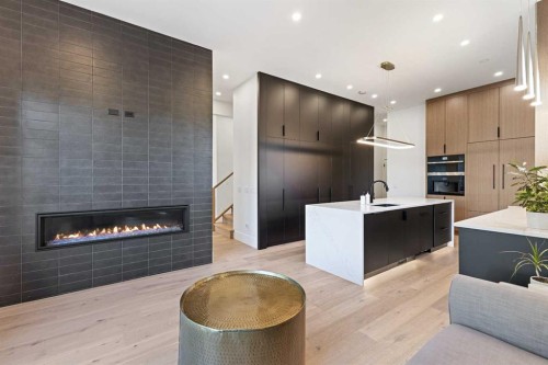 809 Drury Avenue Ne, Calgary, AB - Indoor Photo Showing Kitchen With Fireplace