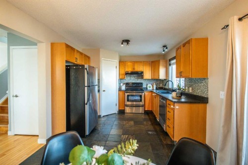 84 Hidden Green Nw, Calgary, AB - Indoor Photo Showing Kitchen With Double Sink