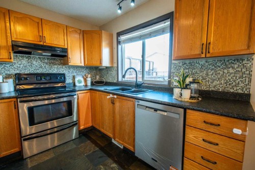 84 Hidden Green Nw, Calgary, AB - Indoor Photo Showing Kitchen With Stainless Steel Kitchen With Double Sink