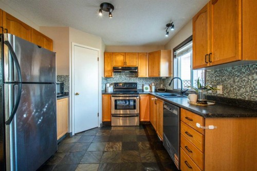 84 Hidden Green Nw, Calgary, AB - Indoor Photo Showing Kitchen With Double Sink