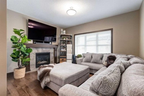 4 Copperpond Grove Se, Calgary, AB - Indoor Photo Showing Living Room With Fireplace