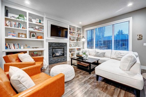 4418 19 Avenue Nw, Calgary, AB - Indoor Photo Showing Living Room With Fireplace