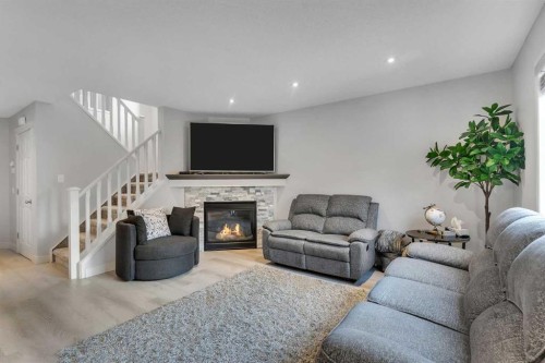 199 Hawkmere Road, Chestermere, AB - Indoor Photo Showing Living Room With Fireplace