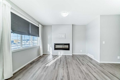224 Carringham Way Nw, Calgary, AB - Indoor Photo Showing Living Room With Fireplace
