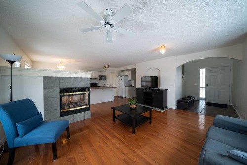 11 Arbour Stone Crescent Nw, Calgary, AB - Indoor Photo Showing Living Room With Fireplace