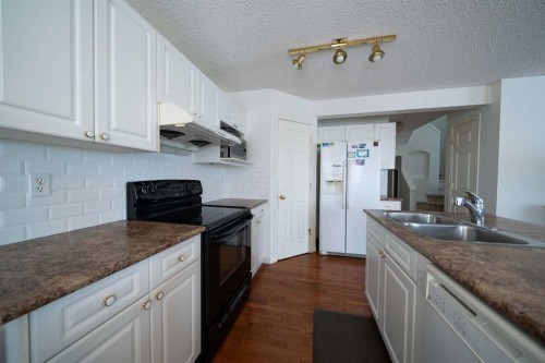 11 Arbour Stone Crescent Nw, Calgary, AB - Indoor Photo Showing Kitchen With Double Sink