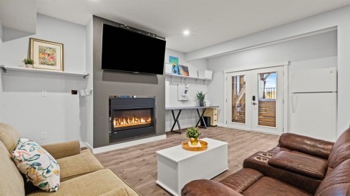 69 Sundown Grove, Cochrane, AB - Indoor Photo Showing Living Room With Fireplace