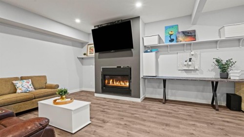 69 Sundown Grove, Cochrane, AB - Indoor Photo Showing Living Room With Fireplace