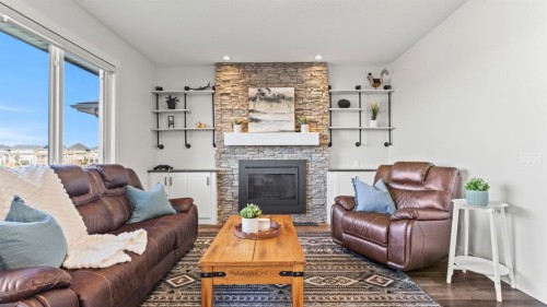 69 Sundown Grove, Cochrane, AB - Indoor Photo Showing Living Room With Fireplace