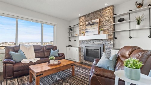 69 Sundown Grove, Cochrane, AB - Indoor Photo Showing Living Room With Fireplace