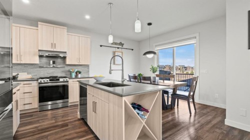 69 Sundown Grove, Cochrane, AB - Indoor Photo Showing Kitchen With Upgraded Kitchen