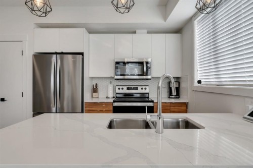 272 Seton Passage Se, Calgary, AB - Indoor Photo Showing Kitchen With Double Sink With Upgraded Kitchen