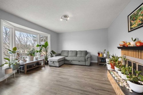 23 Edgedale Road Nw, Calgary, AB - Indoor Photo Showing Living Room With Fireplace